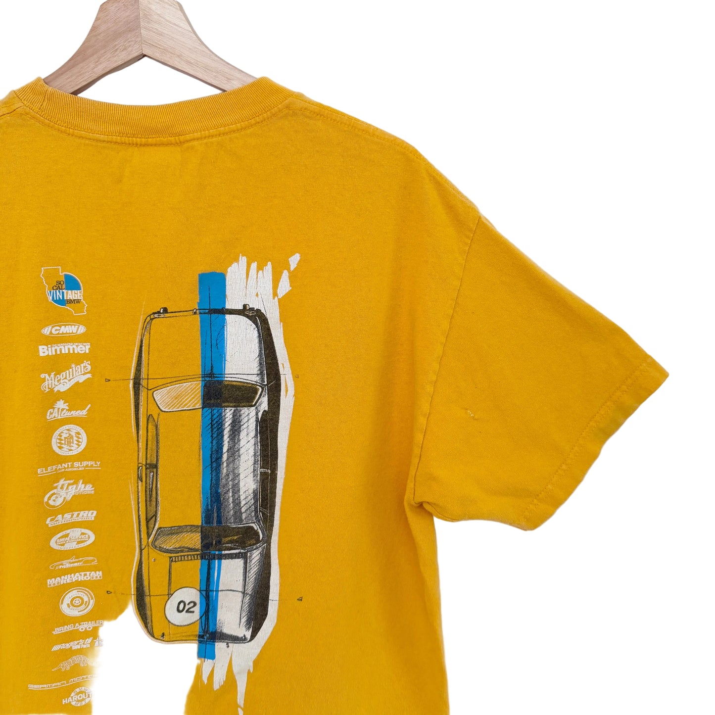 Yellow t-shirt with car graphic and text on a white background