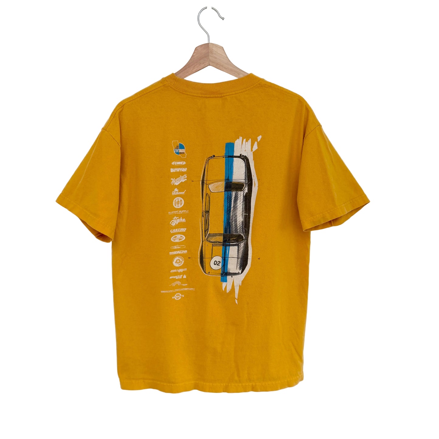 Yellow t-shirt with graphic design on a hanger against a white background