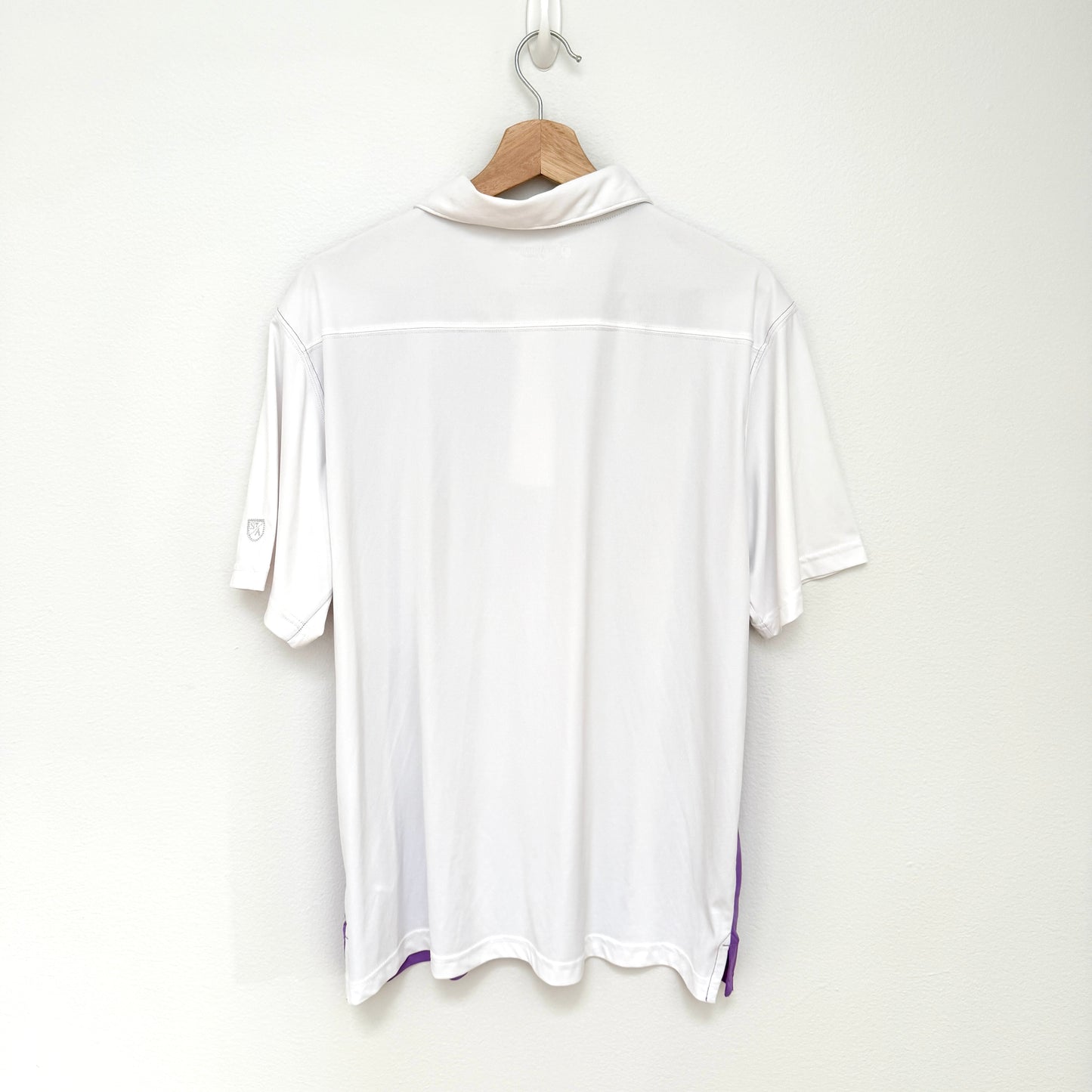 White t-shirt on a hanger against a white background