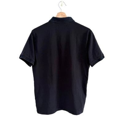 Navy polo shirt on a hanger against a white background