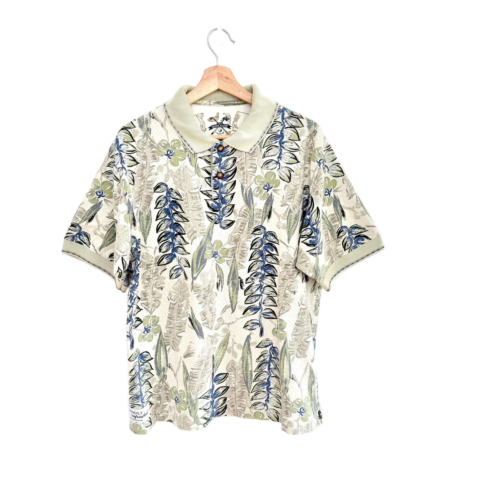 Floral patterned shirt on a hanger against a white background