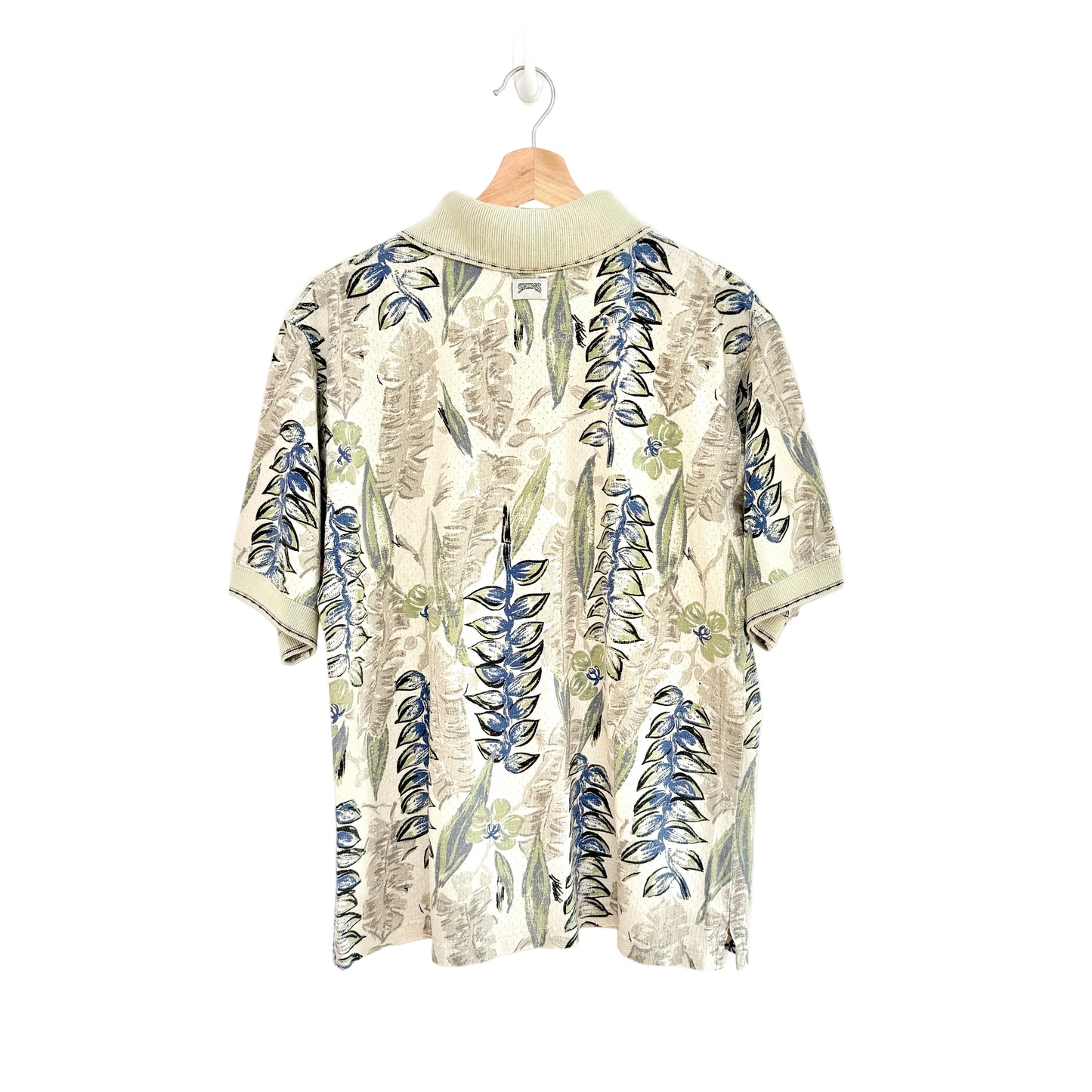 Floral patterned shirt on a hanger against a white background