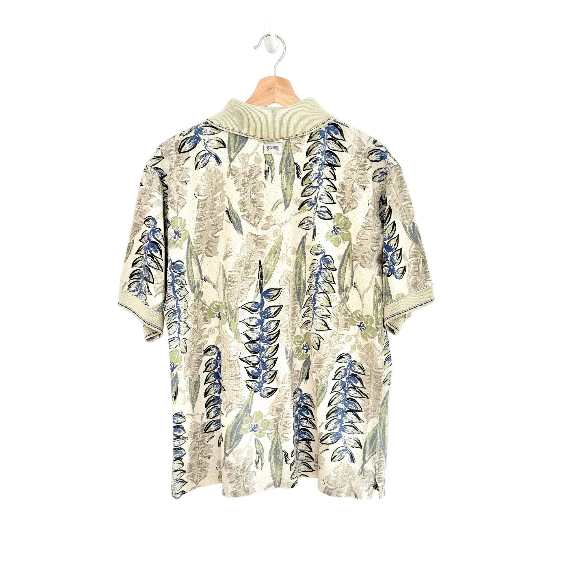 Floral patterned shirt on a hanger against a white background
