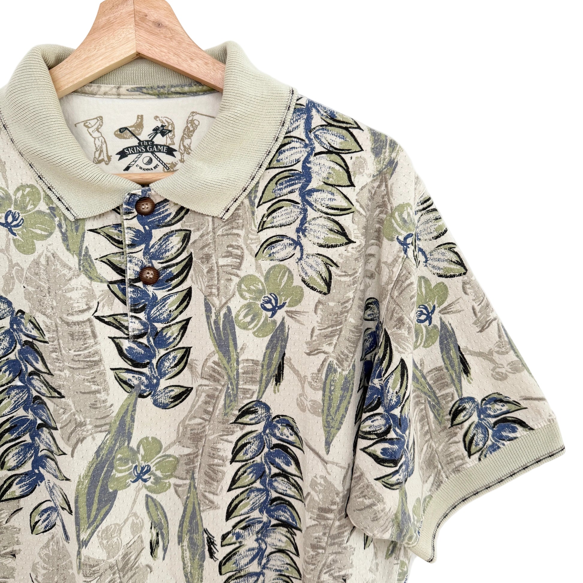 Floral patterned shirt on a hanger with a visible brand label.