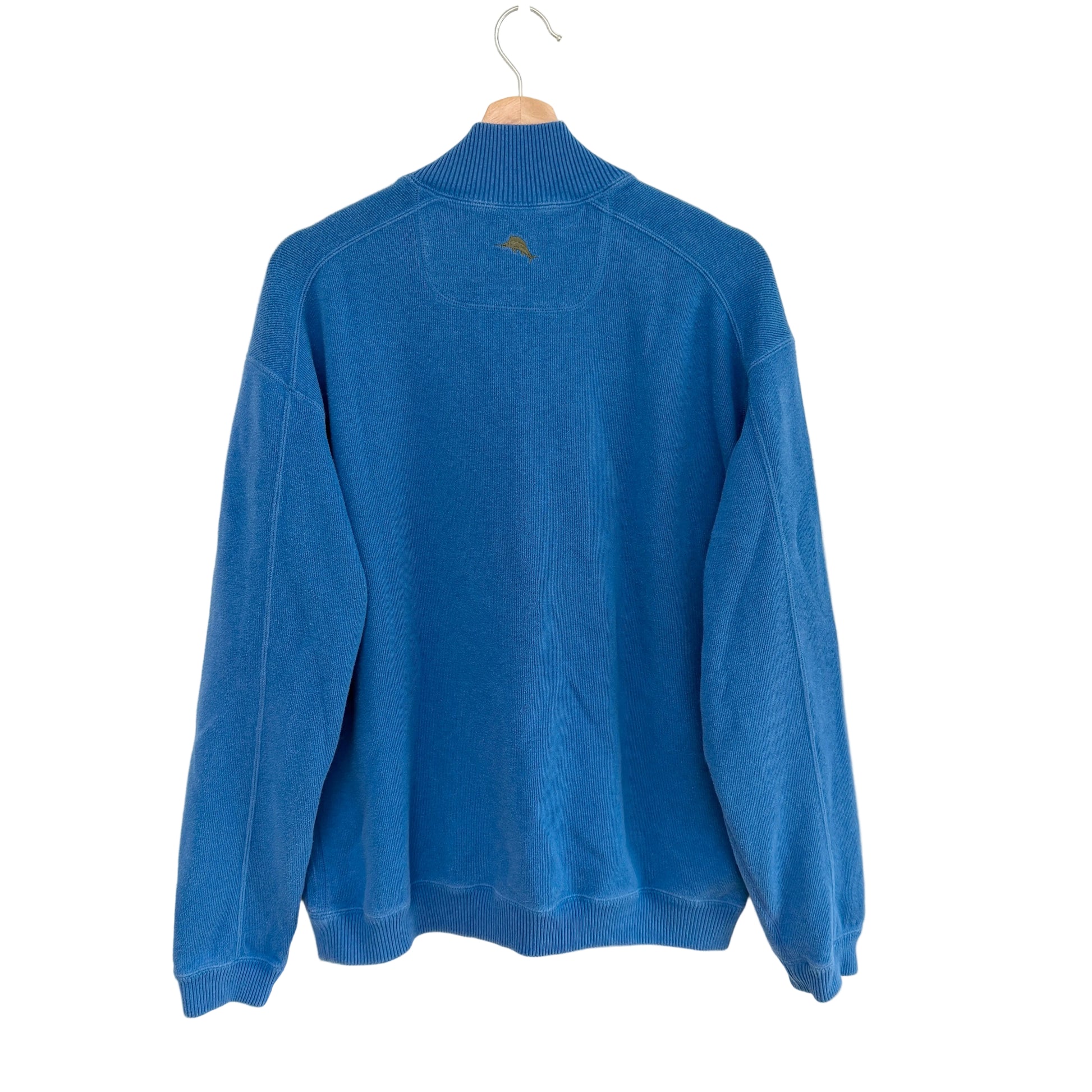 Blue sweater on a hanger against a white background