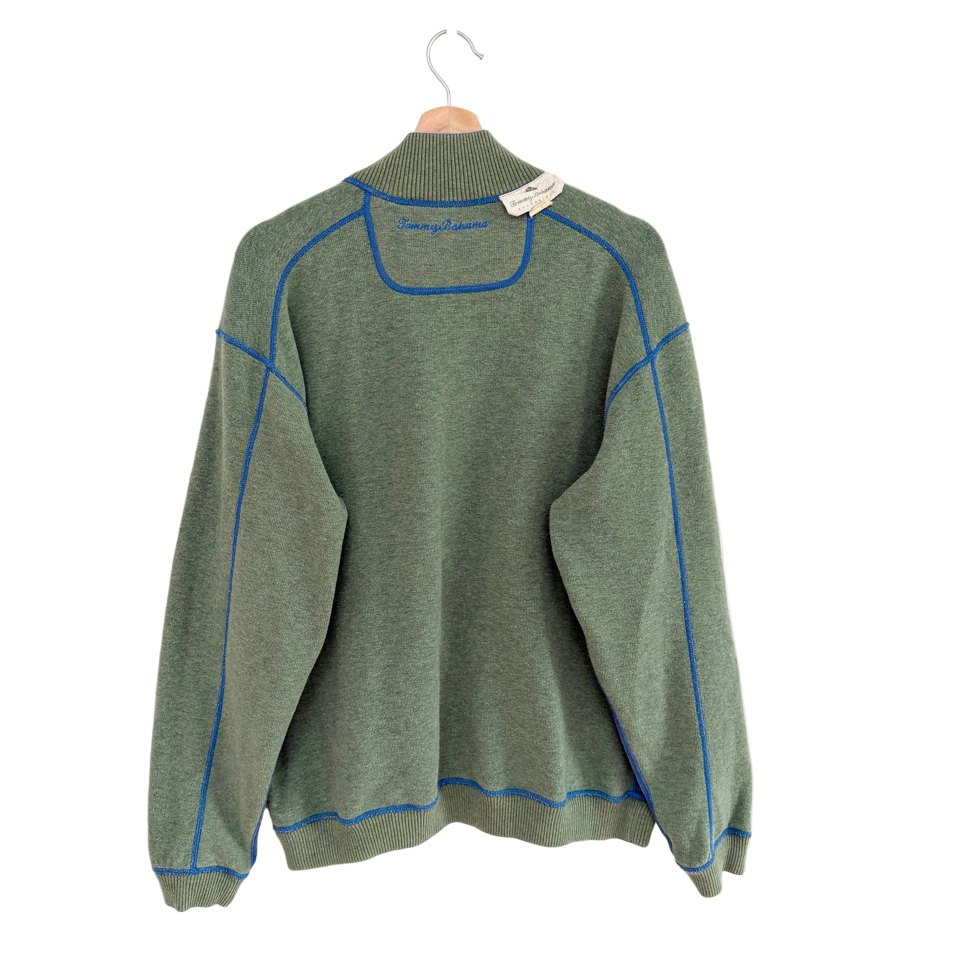 Green sweater with blue accents on a white background