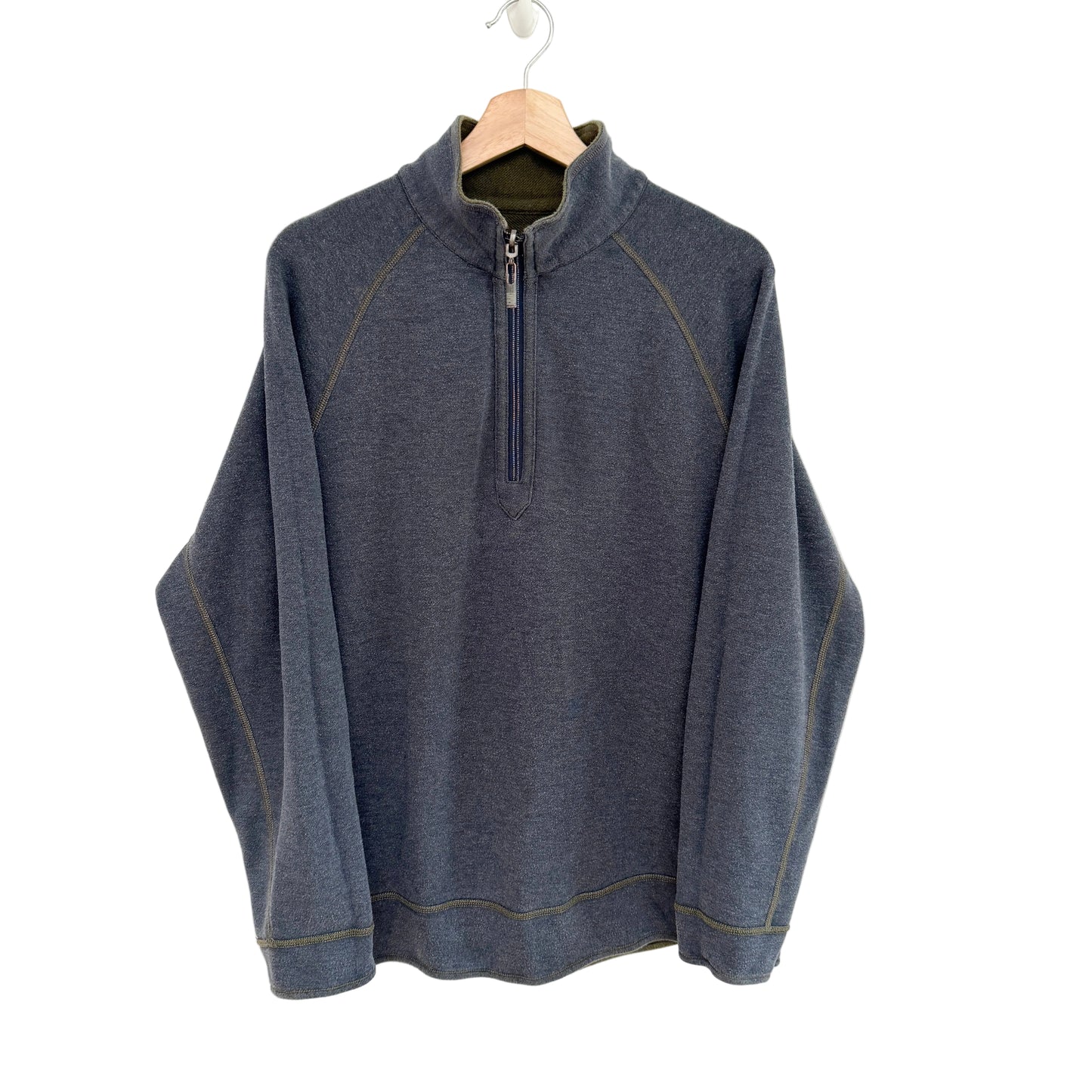 Blue grey pullover with a quarter zip on a hanger against a white background