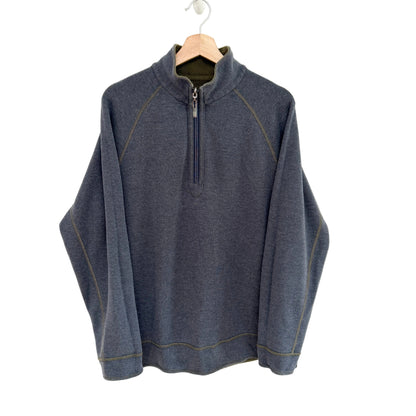 Blue grey pullover with a quarter zip on a hanger against a white background