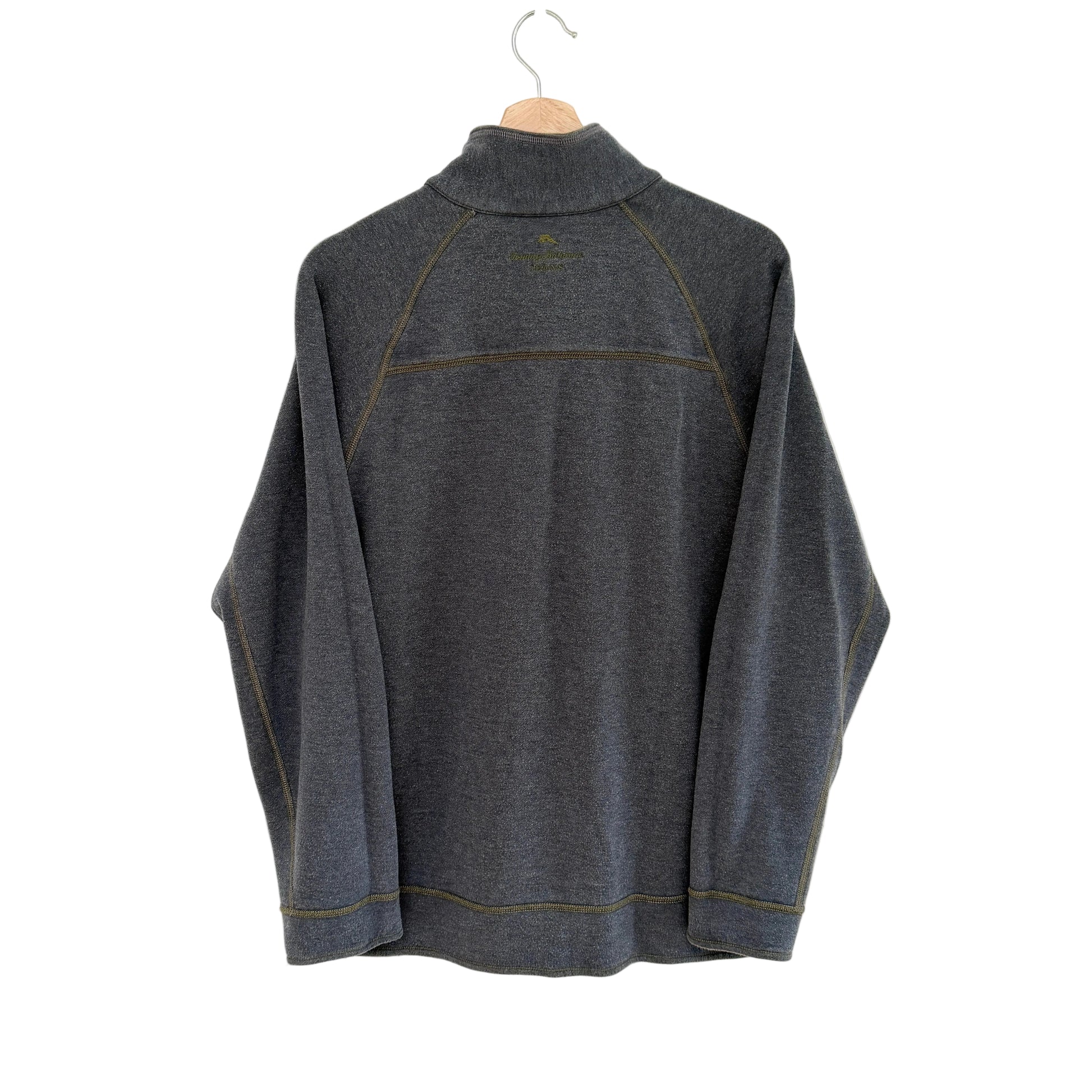 Gray pullover on a hanger against a white background