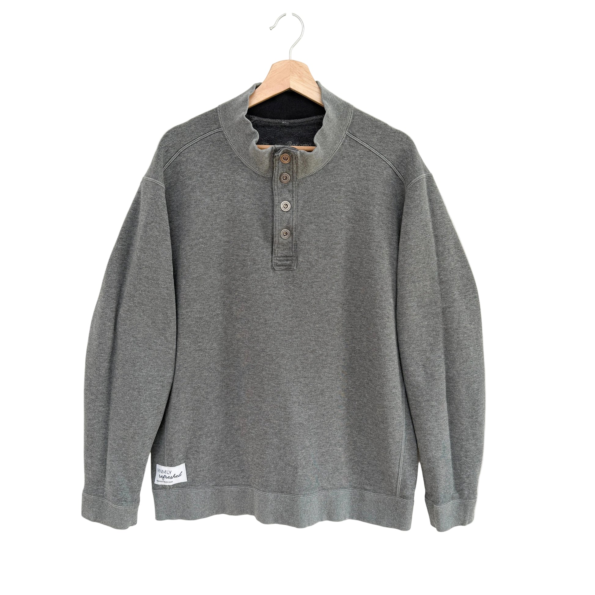 Gray sweatshirt on a hanger against a white background