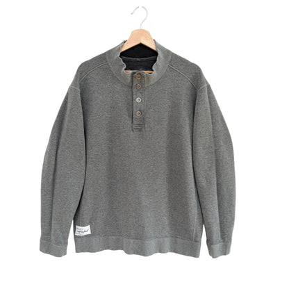 Gray sweatshirt on a hanger against a white background