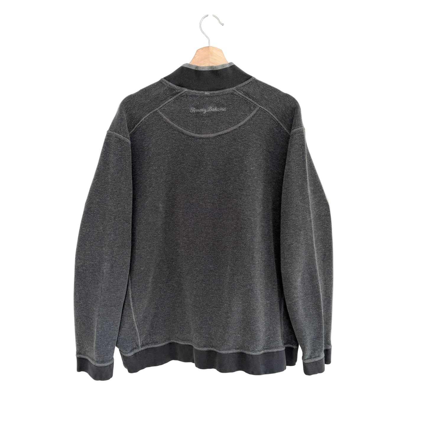 Gray sweatshirt on a hanger against a white background
