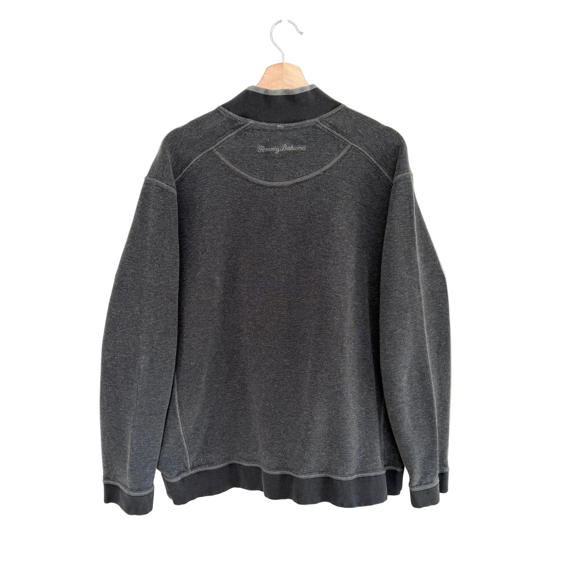 Gray sweatshirt on a hanger against a white background