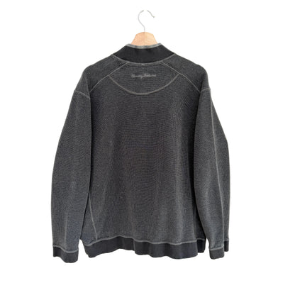 Gray sweatshirt on a hanger against a white background