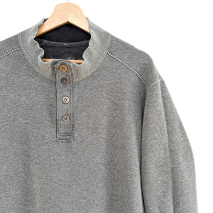 Gray henley shirt on a wooden hanger against a white background