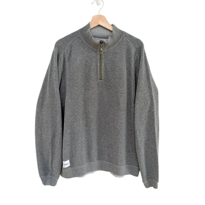Gray pullover with a quarter zip on a hanger against a white background