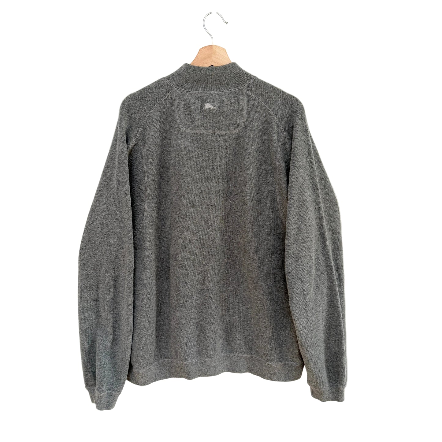 Gray fleece pullover on a hanger against a white background