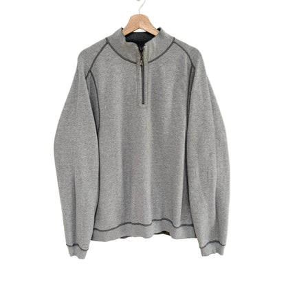 Gray pullover with a quarter zip on a hanger against a white background