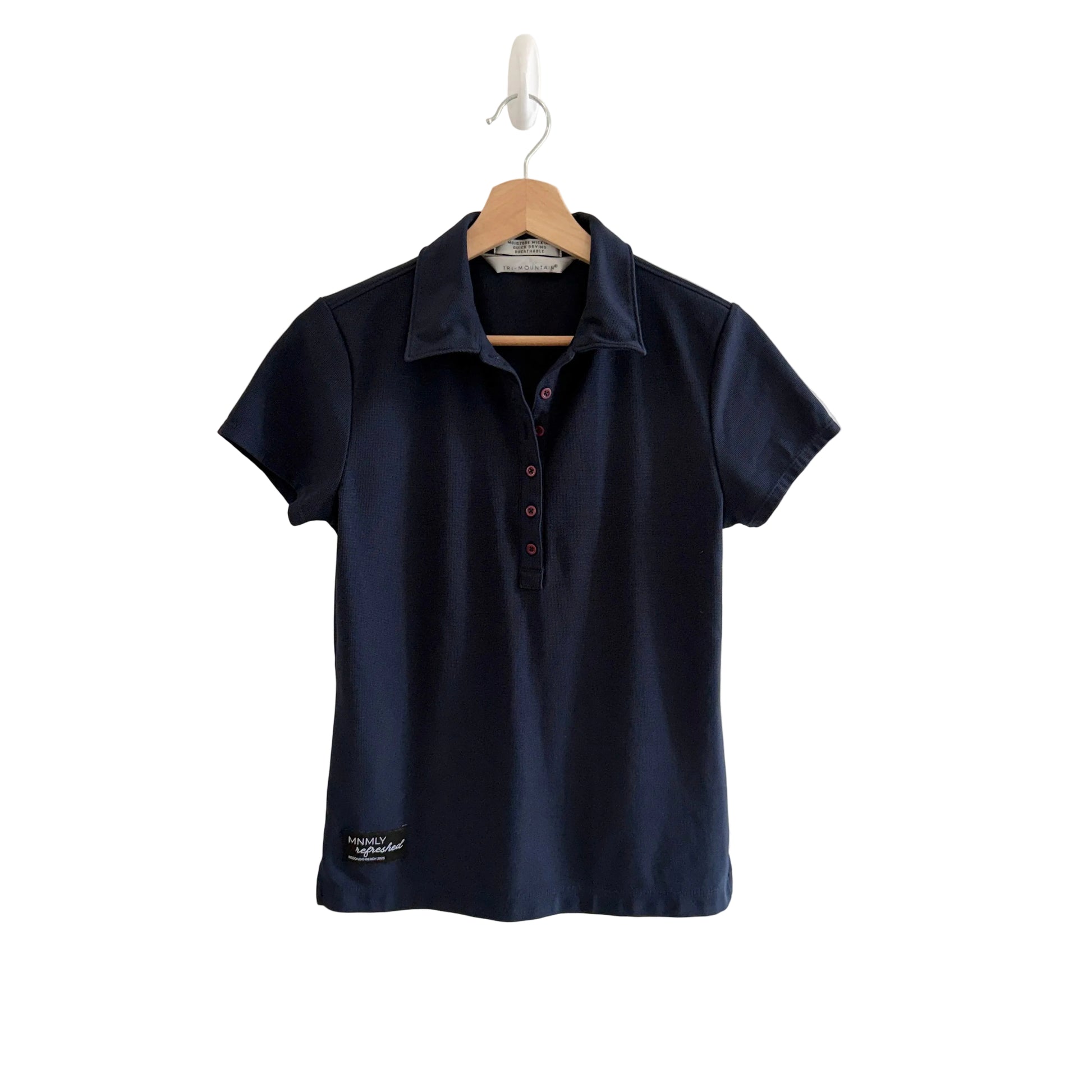 Navy blue polo shirt on a hanger against a white background