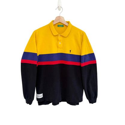 Color-blocked long-sleeve polo shirt with yellow, blue, and red stripes on a white background.