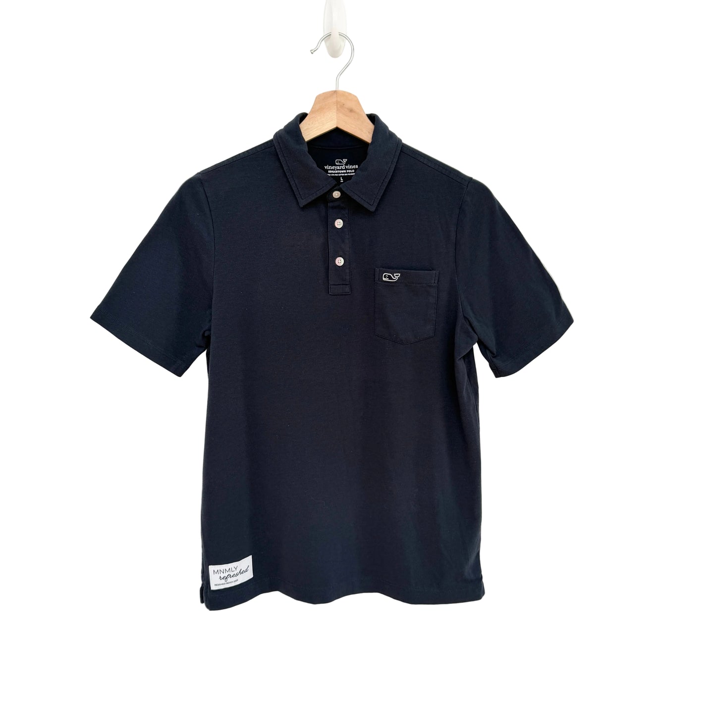 Navy polo shirt with a pocket on a hanger against a white background