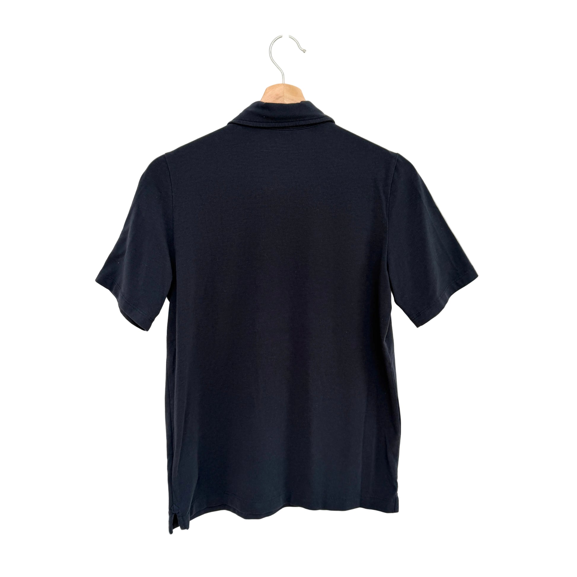 Navy blue polo shirt on a hanger against a white background