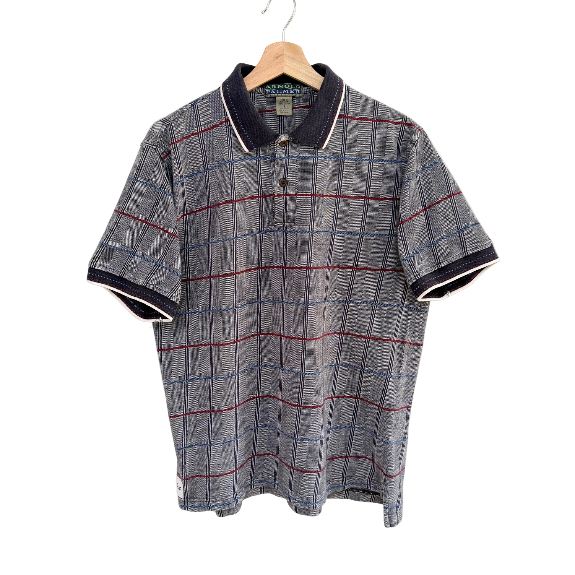 Plaid shirt with red and blue stripes on a hanger against a white background