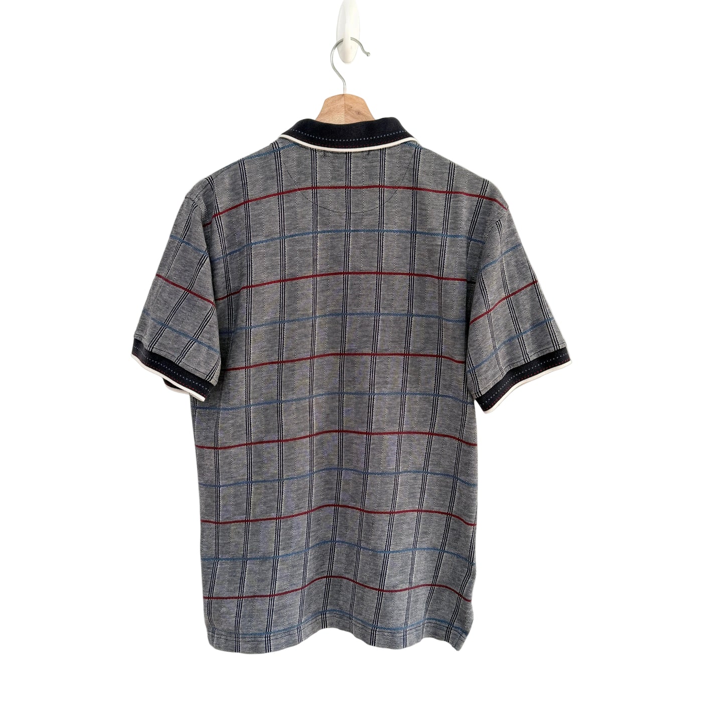 Plaid shirt on a hanger against a white background