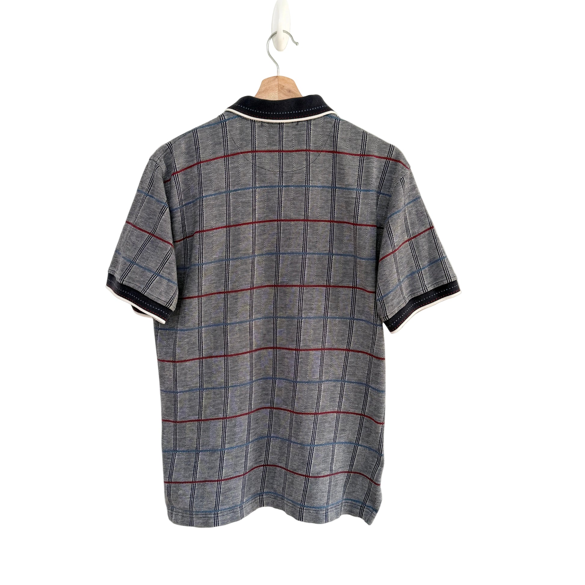 Plaid shirt on a hanger against a white background