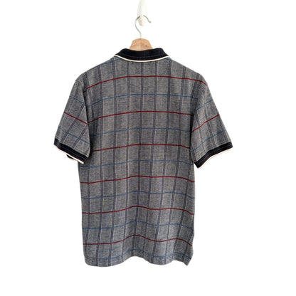 Plaid shirt on a hanger against a white background
