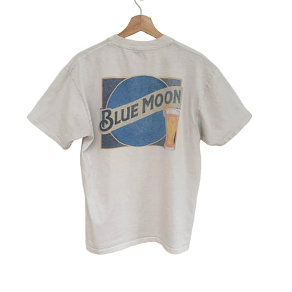 White t-shirt with Blue Moon beer logo on a wooden hanger against a white background