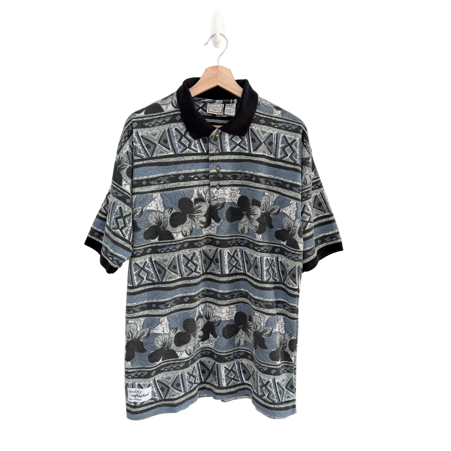 Patterned shirt on a hanger against a white background