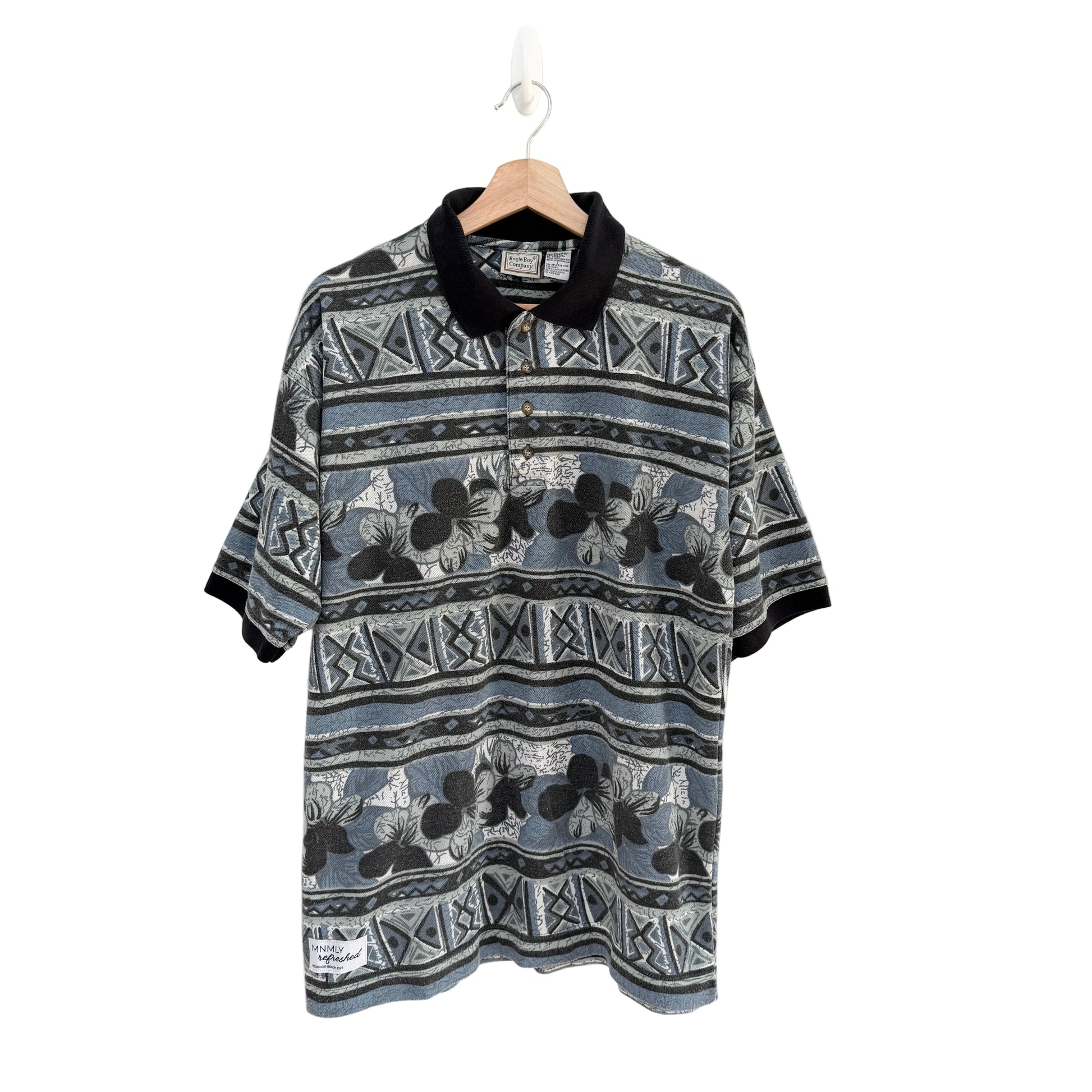 Patterned shirt on a hanger against a white background