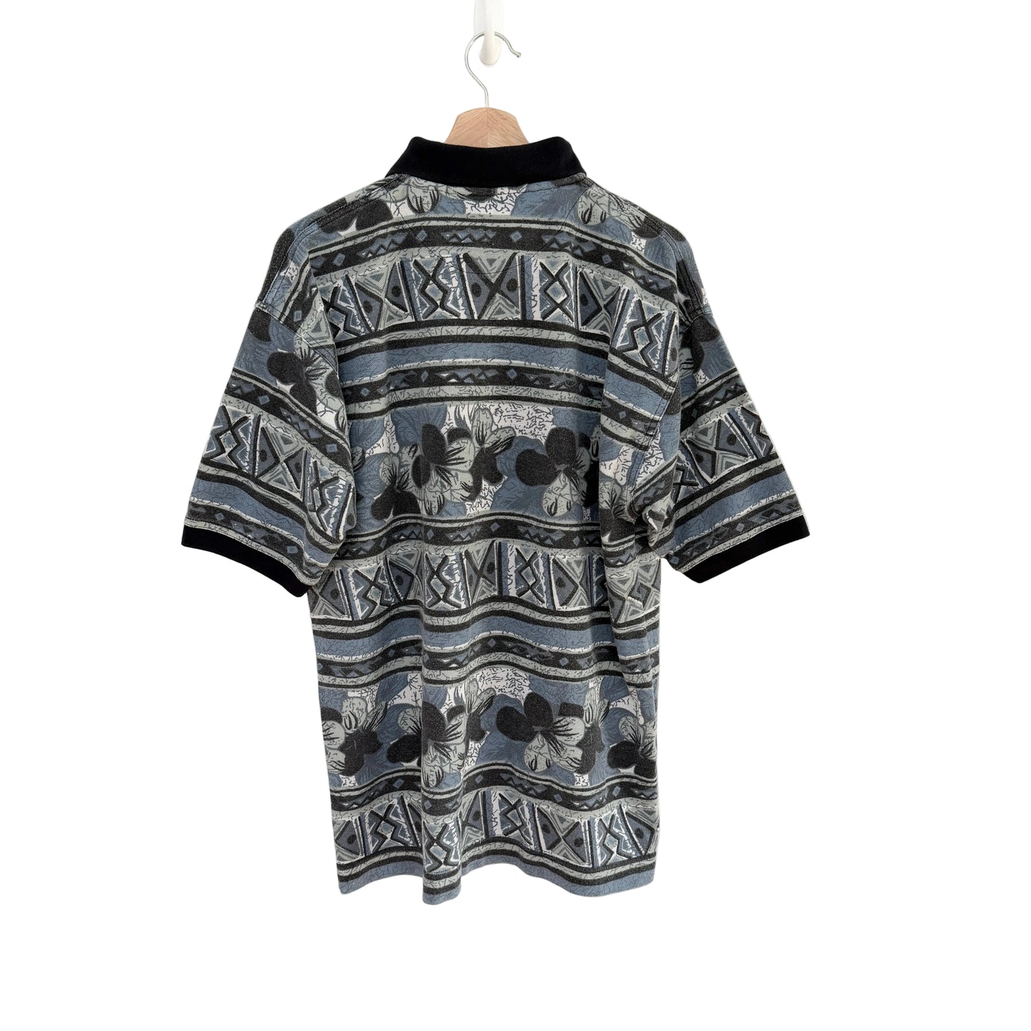 Patterned shirt on a hanger against a white background