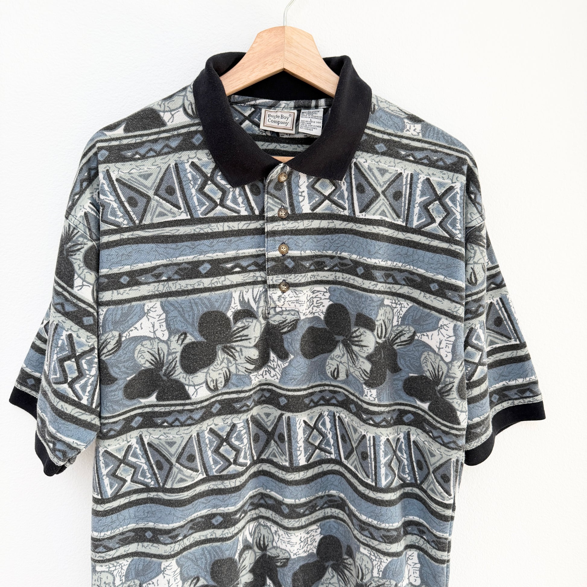 Patterned shirt on a hanger with a white background