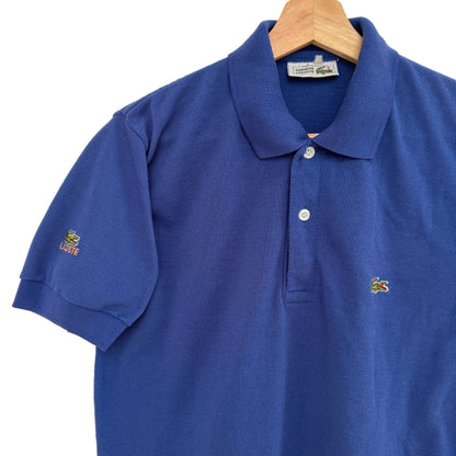 Blue polo shirt on a hanger against a white background