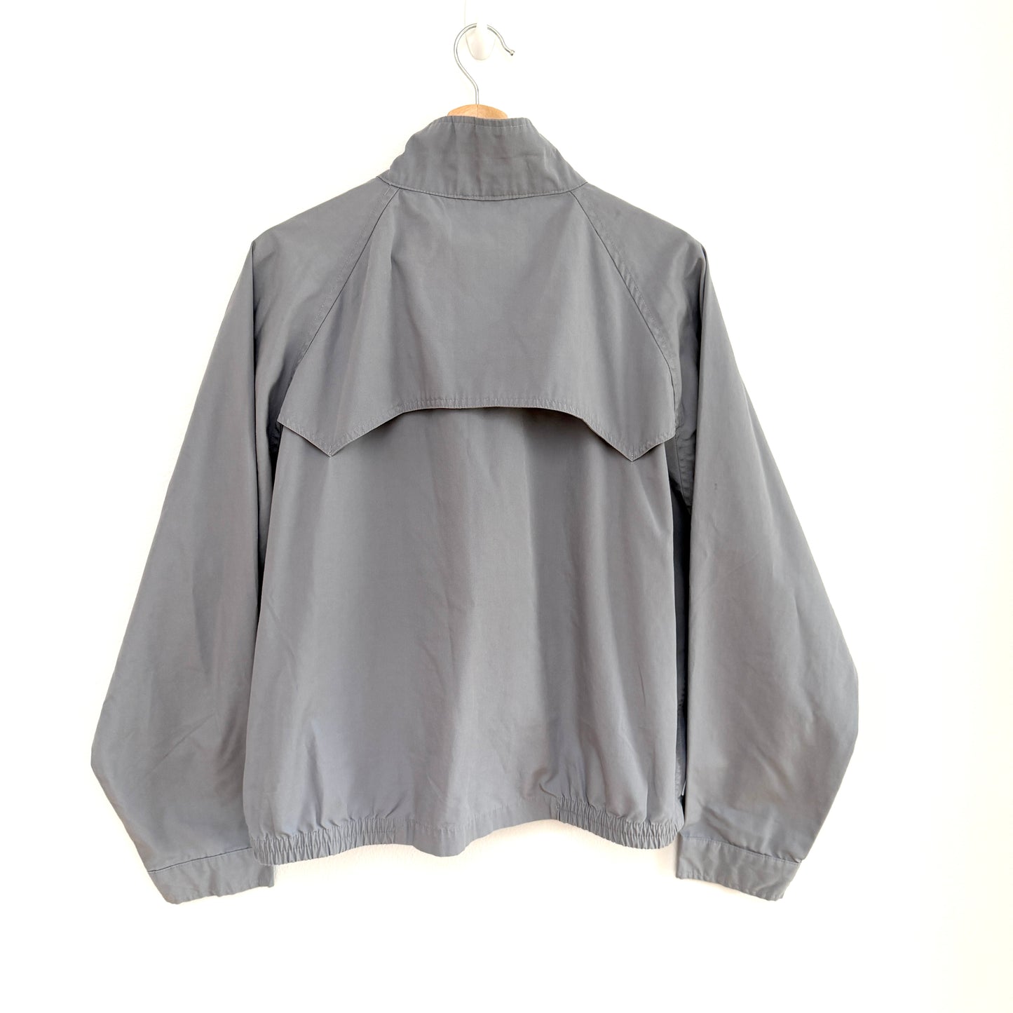 Gray jacket on a hanger against a white background