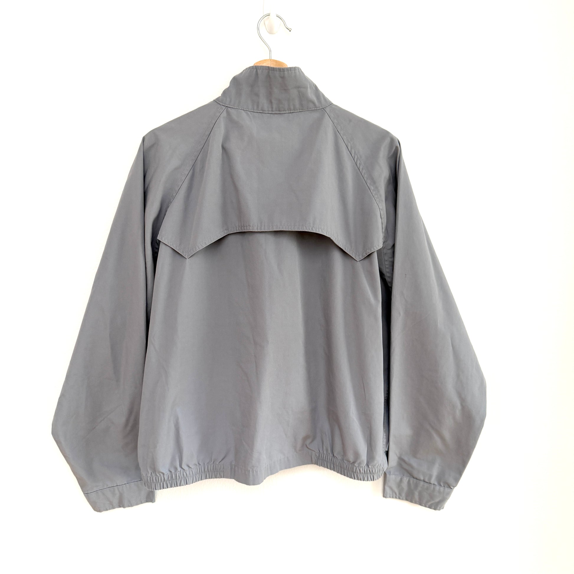 Gray jacket on a hanger against a white background