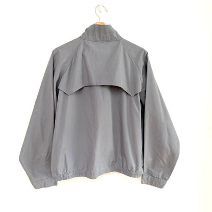 Gray jacket on a hanger against a white background