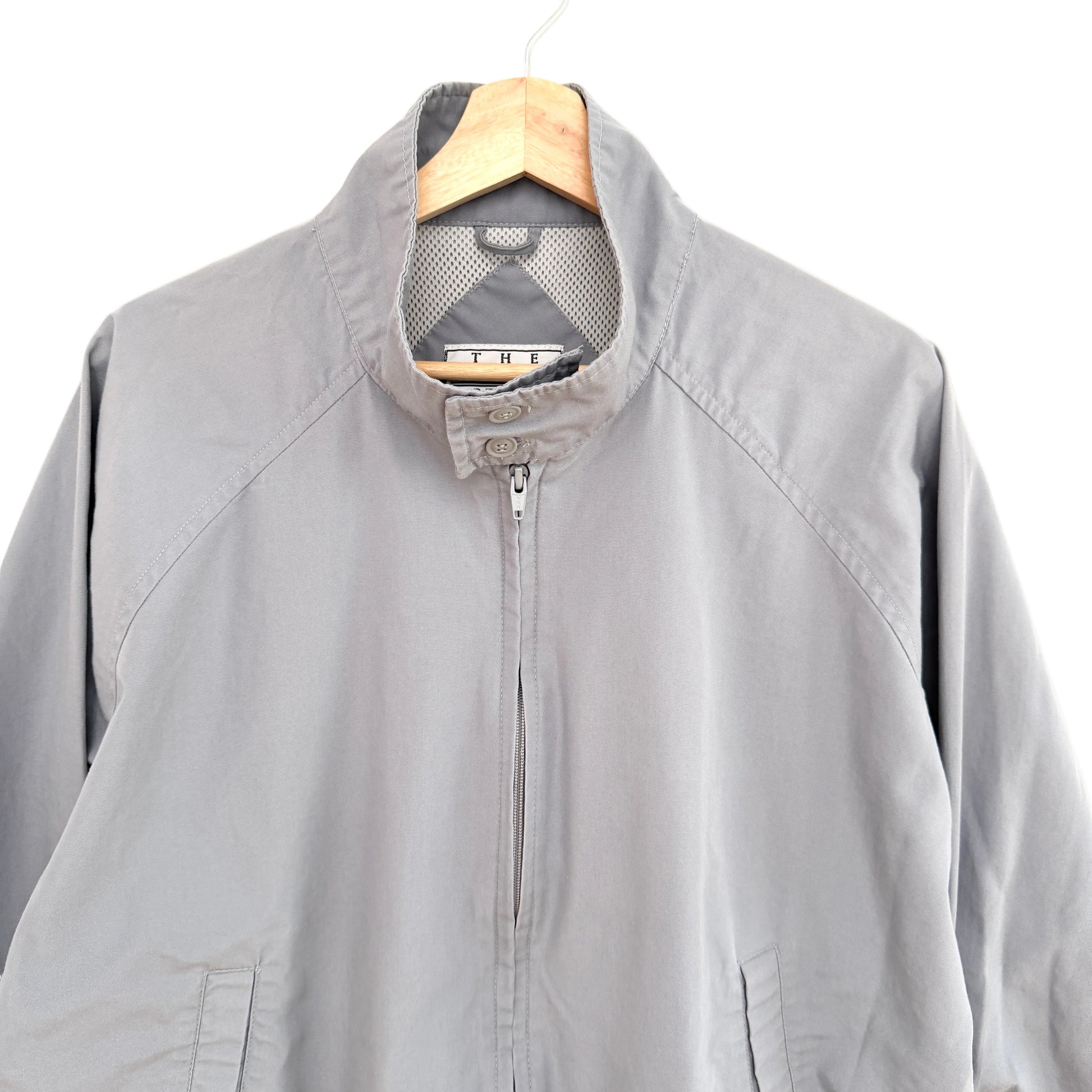 Gray jacket on a hanger against a white background