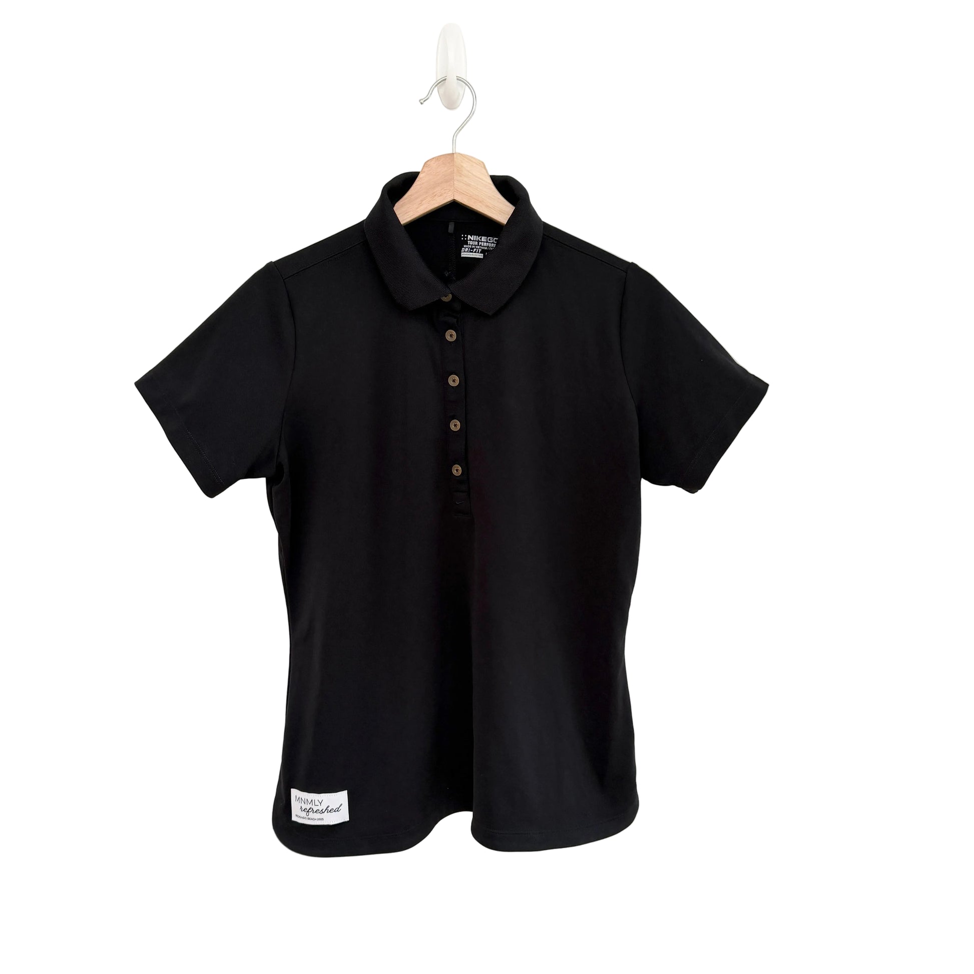 Black polo shirt on a hanger against a white background