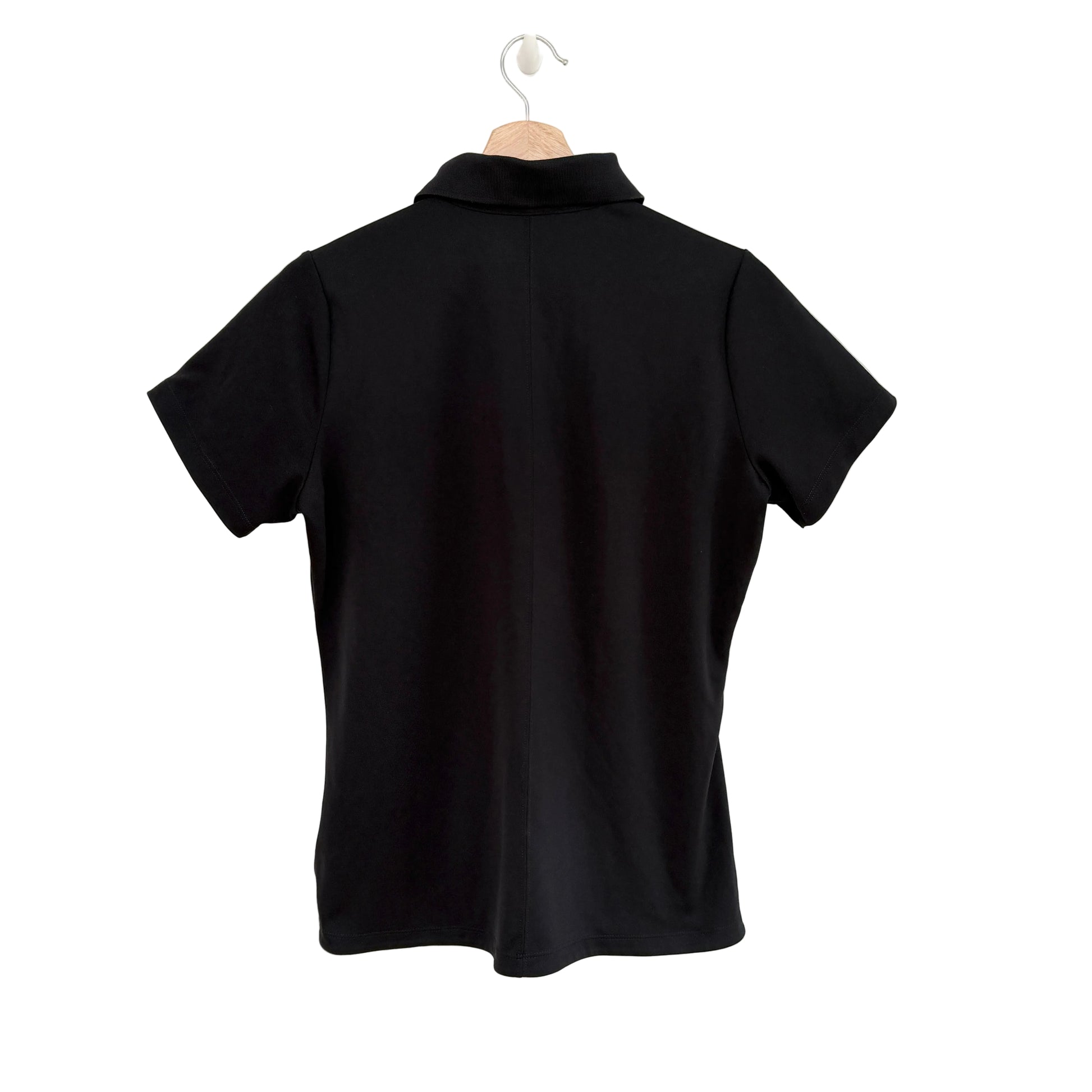 Black polo shirt on a hanger against a white background