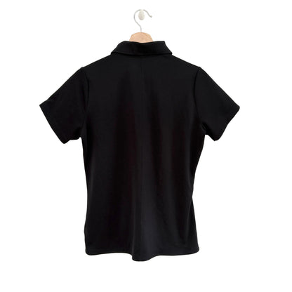 Black polo shirt on a hanger against a white background