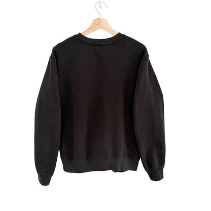 Black sweatshirt on a wooden hanger against a white background