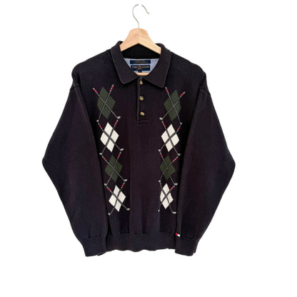Navy argyle sweater on a hanger against a white background