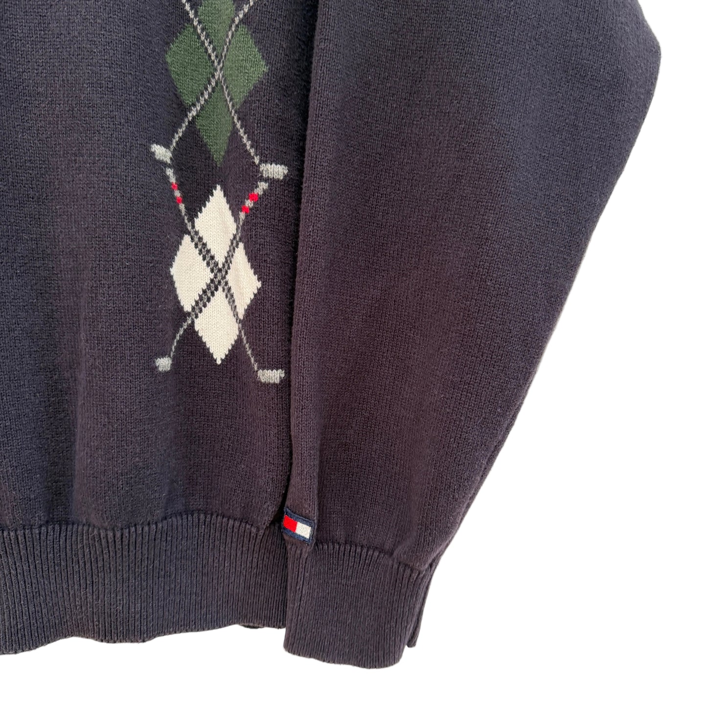 Navy sweater with argyle pattern on a white background